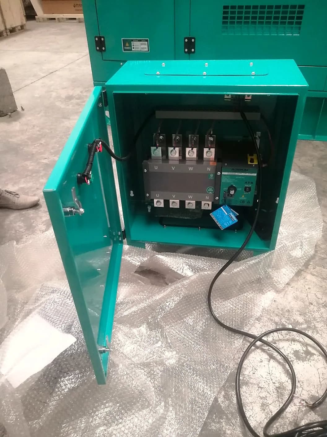 Changeover panel opened showing a four-pole automatic transfer switch wired to U, V, W and N terminals