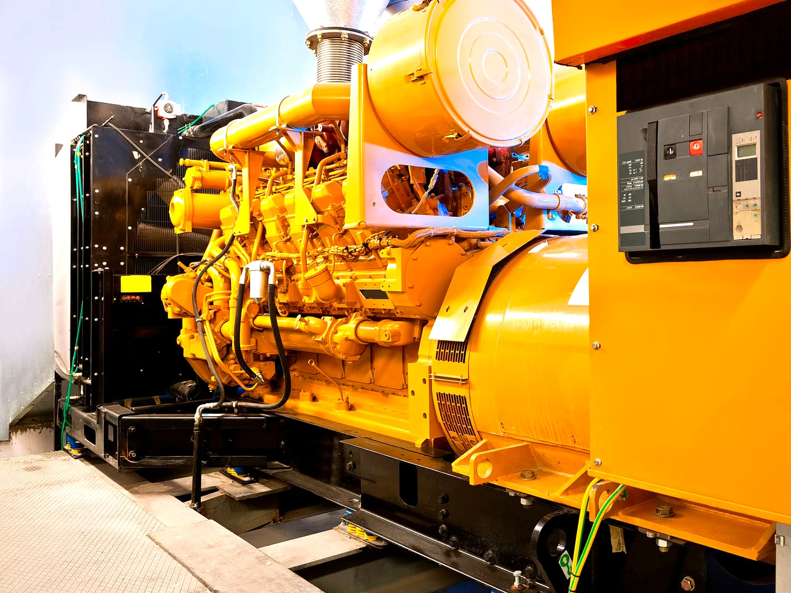 Caterpillar open-frame diesel generator professionally installed in a plant room
