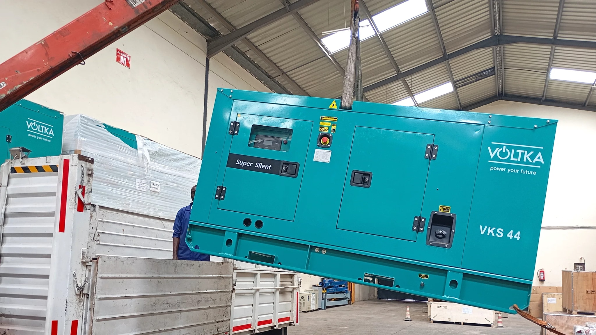 VOLTKA VKS 44 super silent generator lowered onto a delivery truck at EmersonEIMS Nairobi